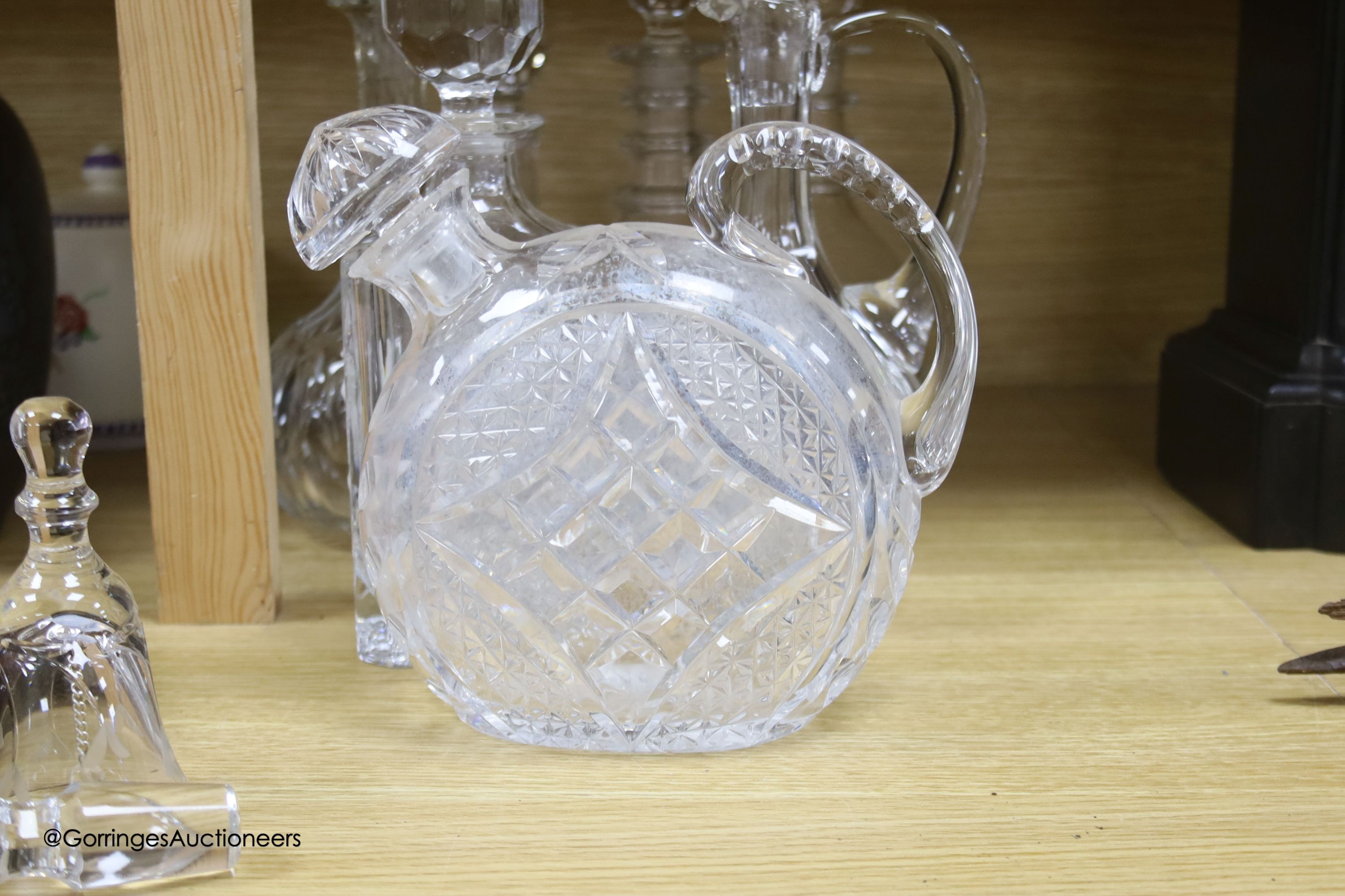 A collection of clear cut glass decanters